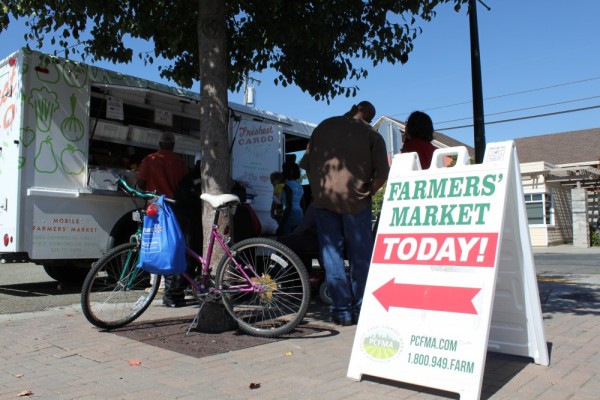 Residents gather on Fred Jackson Way to purchase fresh fruit and vegetables.